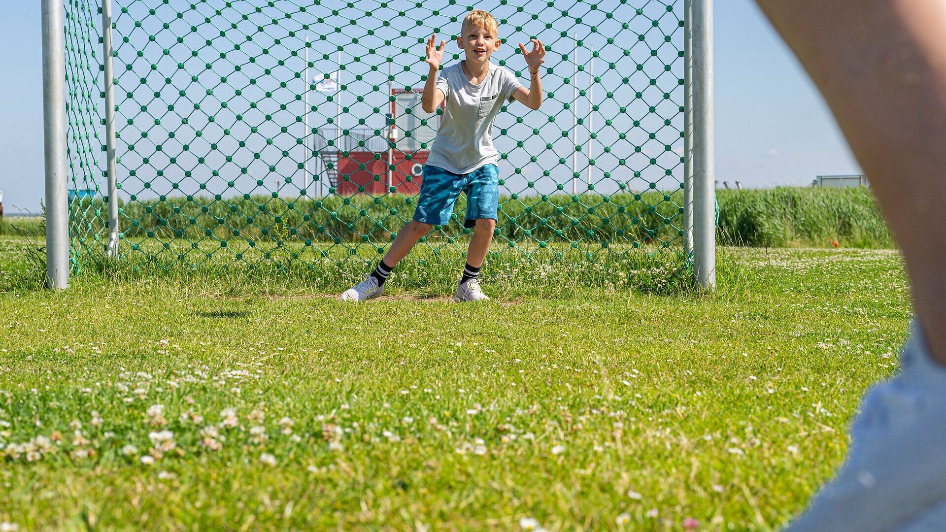 Ein Junge steht im Fußballtor auf dem Spielplatz in Altenbruch